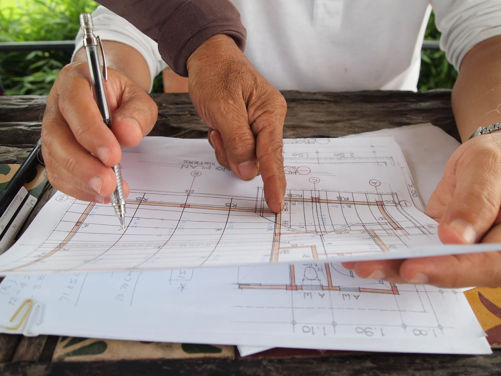 Hands reviewing architectural plans